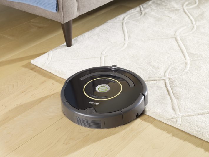 The Roomba 650 navigates from hardwood to a carpeted section.