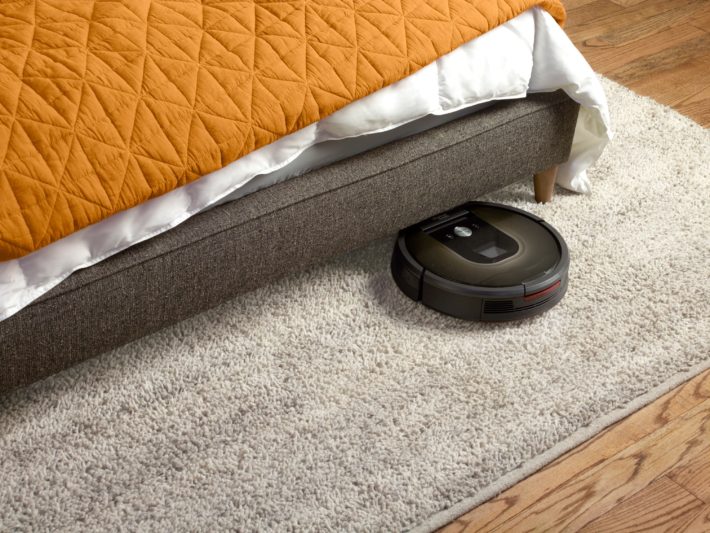 The Roomba 980 navigates its way underneath a bed.