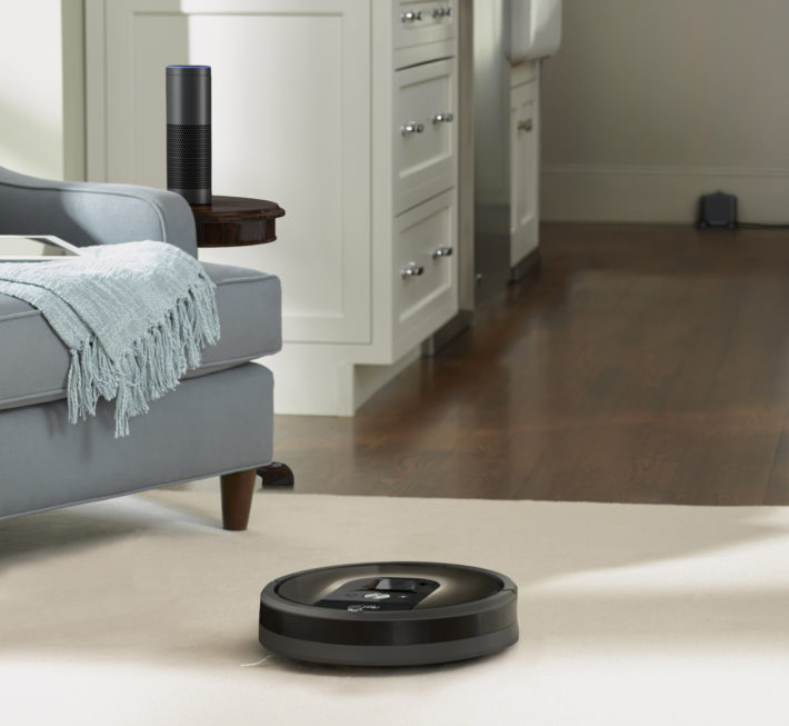 iRobot Roomba vacuuming on a mixed type floor with both carpet and hardwood.