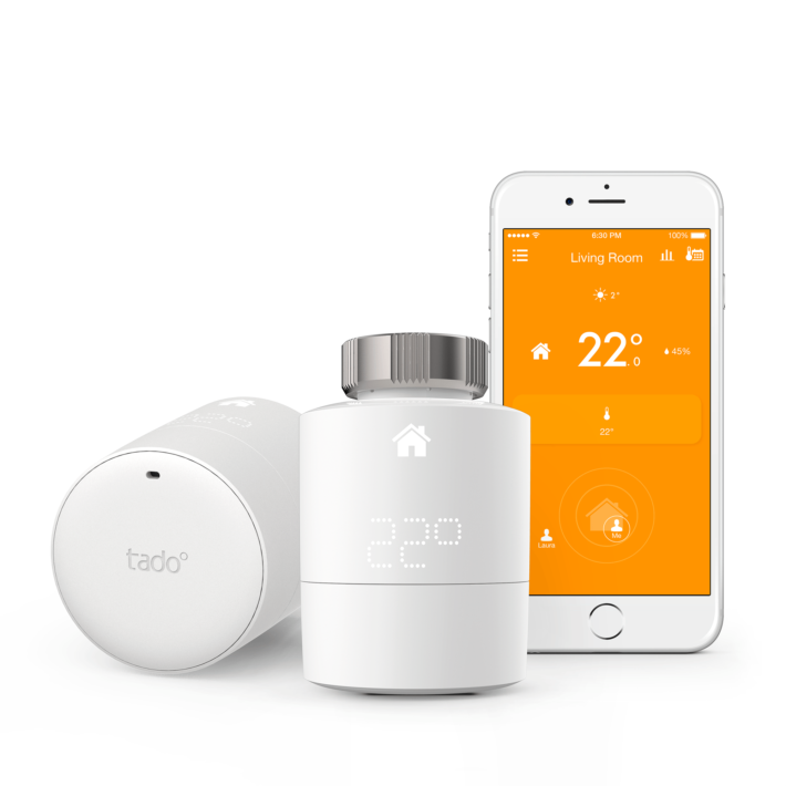 Tado's radiator kit and a smartphone with Tado's mobile application on the screen.