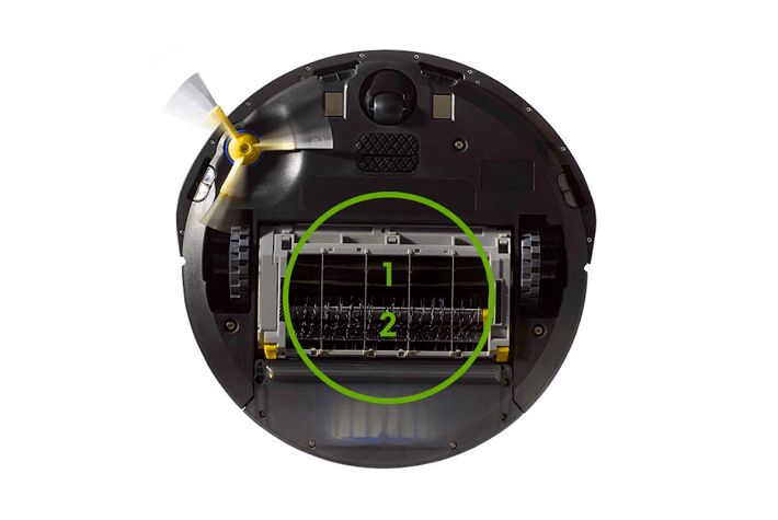 An underneath view of a Roomba vacuum with emphasis on the two multi-surface brushes.