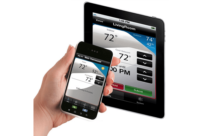 A smartphone and tablet both displaying the Honeywell mobile app onscreen.