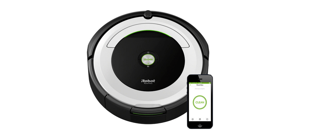 The Roomba 695 pictured alongside a smartphone showing Roomba's mobile app interface.